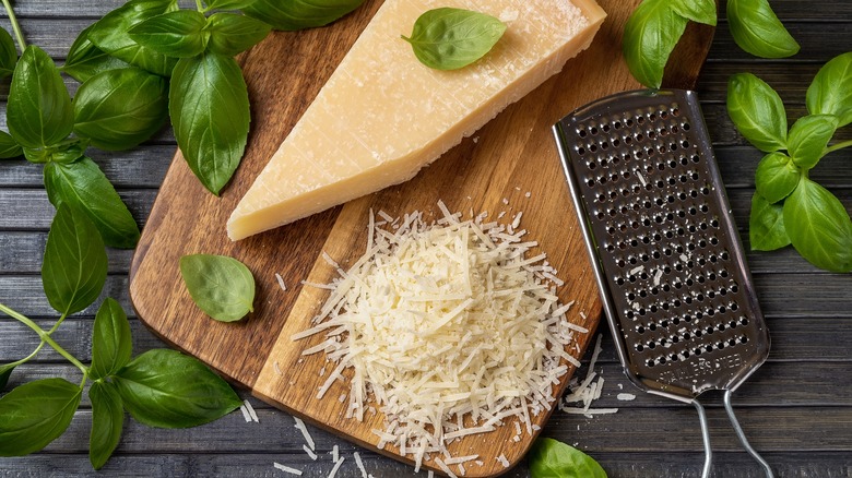 A wedge of cheese with a grater