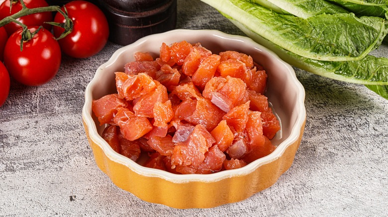 Cubed uncooked salmon in bowl