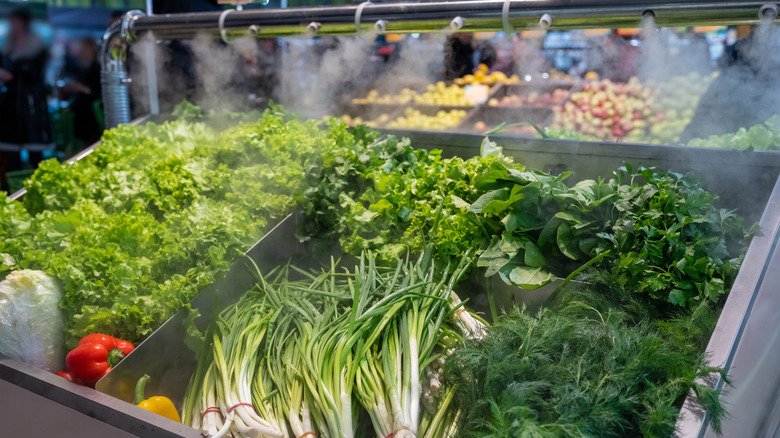 Green veggies getting misted at grocery store