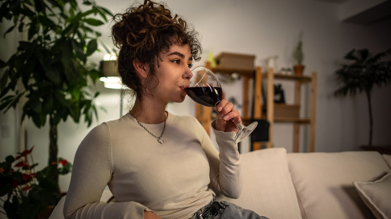 Woman relaxing with red wine