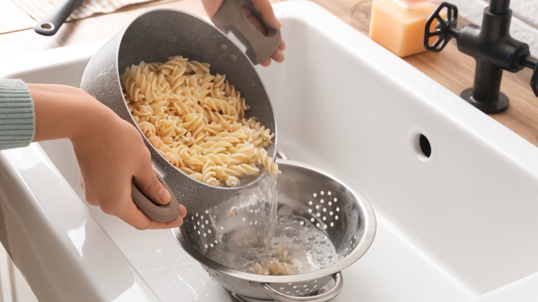Pasta being drained into colander