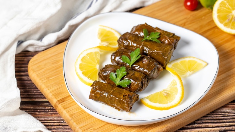 Canned dolmas with lemon on a plate