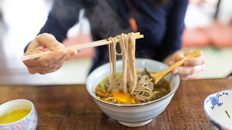 Woman eating vegetarian soba in Japan