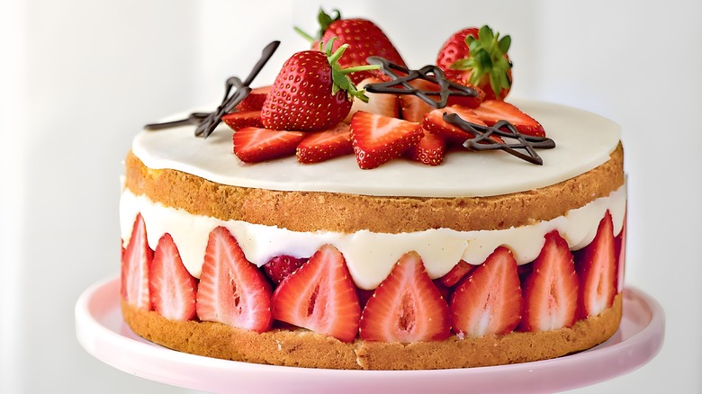 Layered strawberry cake on stand