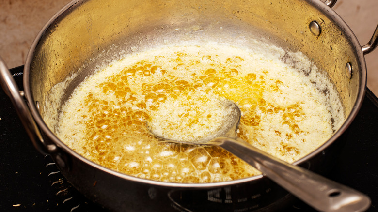 Ghee cooking in a metal pan