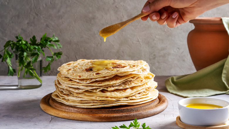 Ghee dripped on a plate of naan