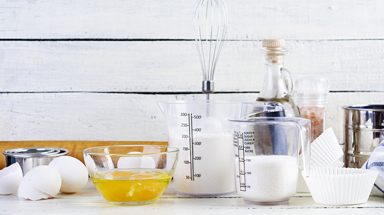 milk and eggs in measuring cups