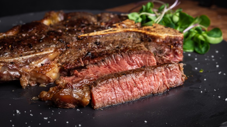 Sliced medium-rare steak on a plate.