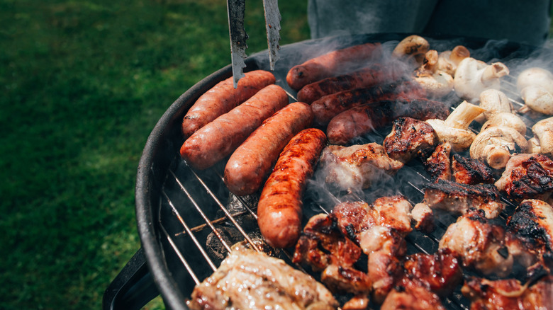 Different meats cooking on a barbecue grill