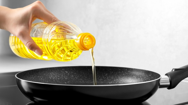 oil being poured into pan