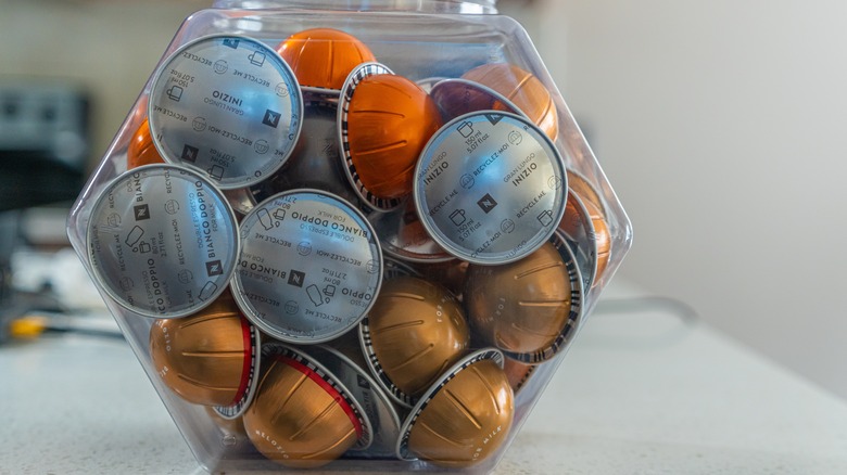 Nespresso pods stored in a plastic container