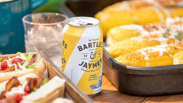 Bartles & Jaymes ginger and lemon wine cooler on table with food