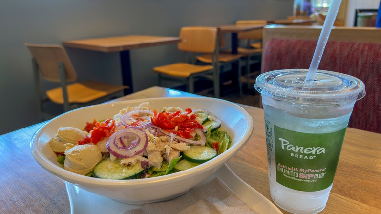 Panera salad and water on table