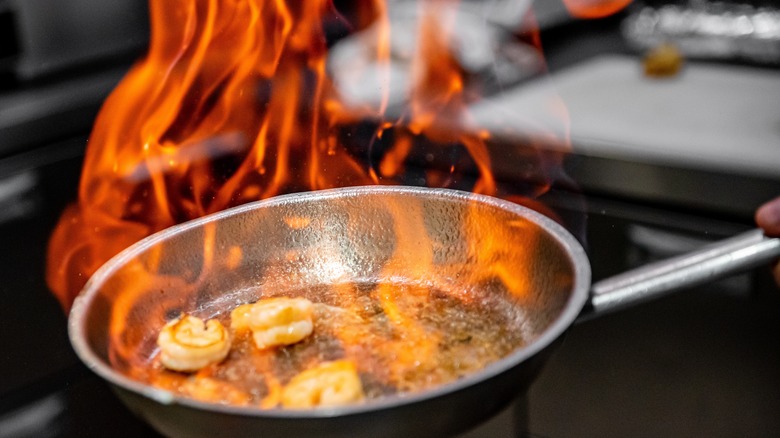 Cooking flambé on shrimps