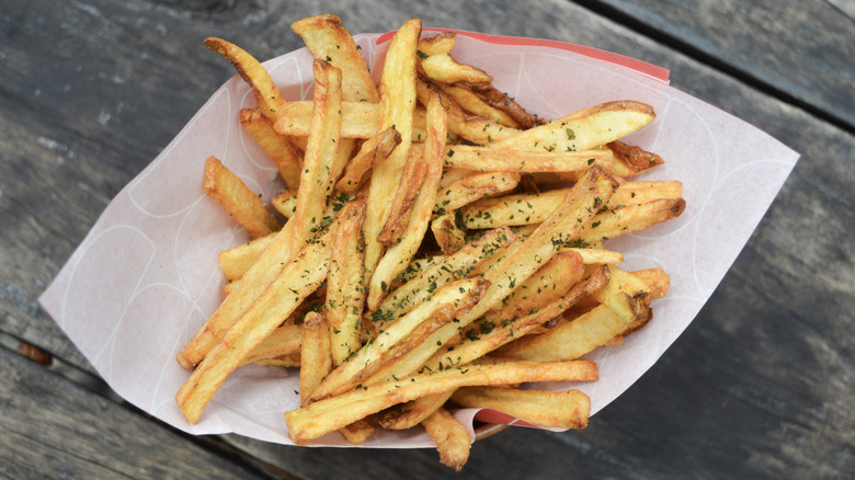 Seasoned fries in a paper-lined basket