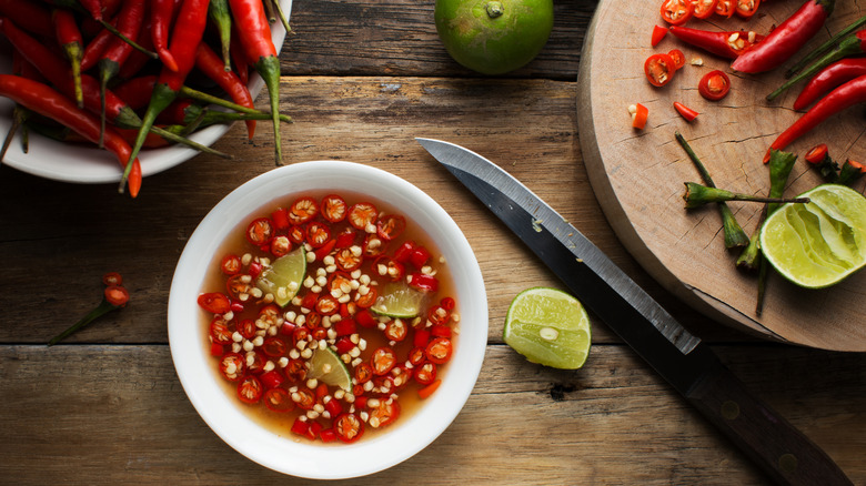 A dish of fish sauce with chiles and lime