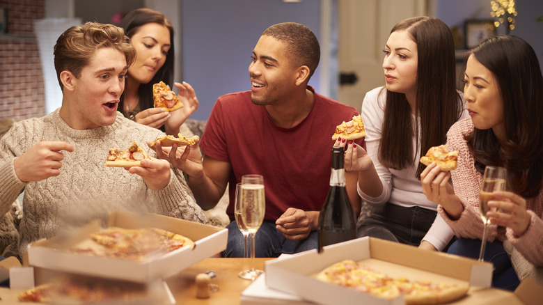 Group of people enjoying pizza