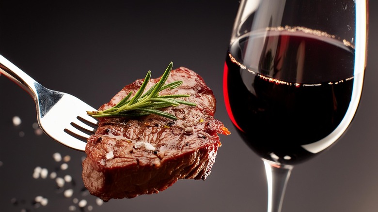 Close Up of Steak Bite with Red Wine Glass