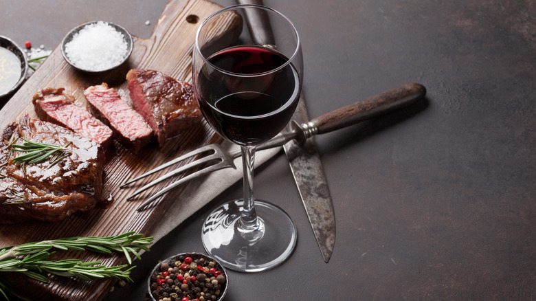 Ribeye Steak on Cutting Board With Wine Glass