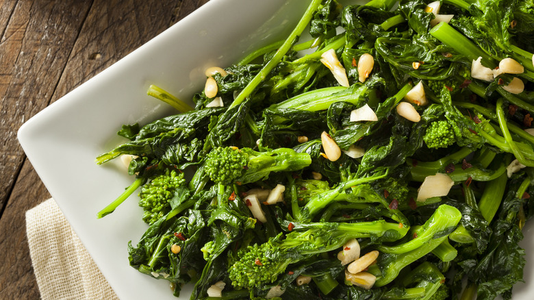 close up of white dish filled with sautéed broccoli rabe