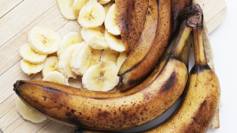 overripe bananas on a cutting board