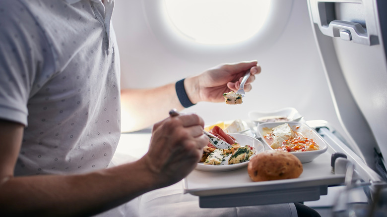 Person eating a meal on plane