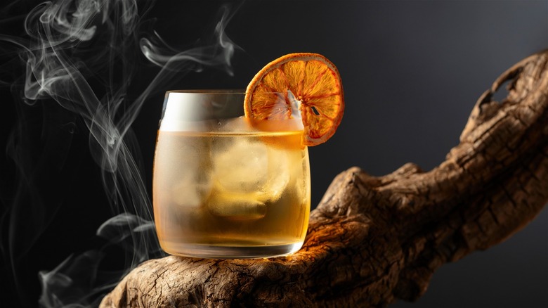 orange cocktail with smoke coming out