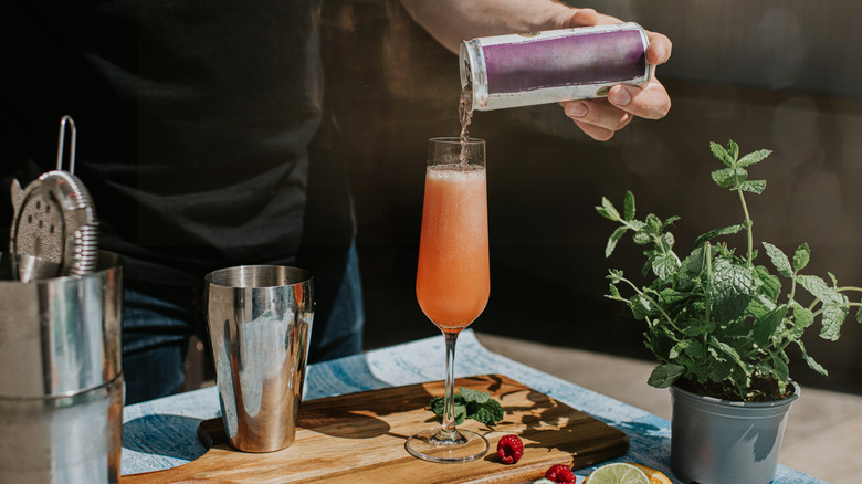 Bartender pouring canned wine into glass