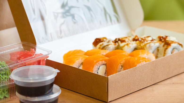 Delivery sushi rolls in a box with sides