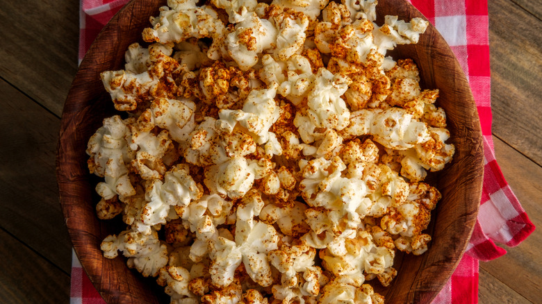 A bowl of popcorn seasoned with red spices