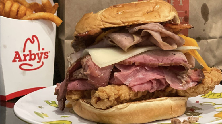 a meat mountain sandwich and box of curly fries