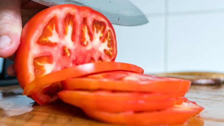 Slicing a tomato close-up