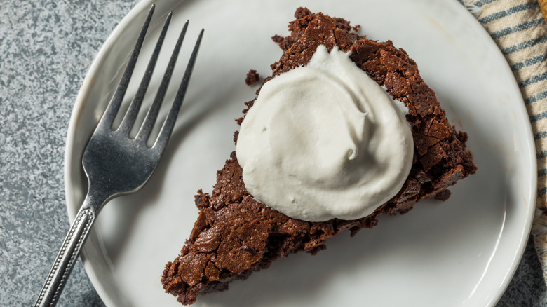 flourless chocolate cake on a plate with a fork