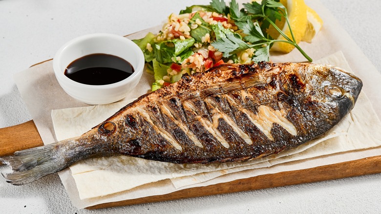 Whole grilled fish and salad