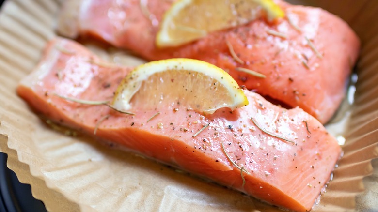 Two salmon fillets in air fryer basket