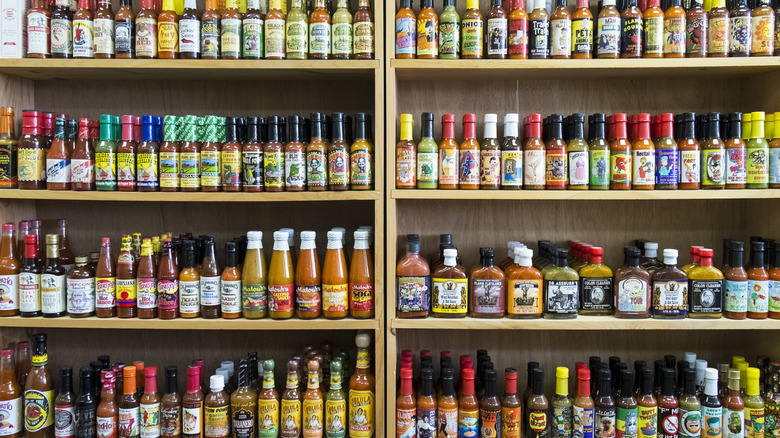 Shelves of various hot sauce brands