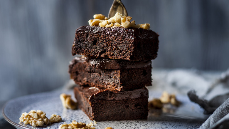 Freshly baked brownies covered in nuts