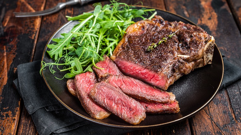 Rare steak on dark plate