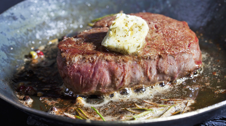 steak in pan with butter