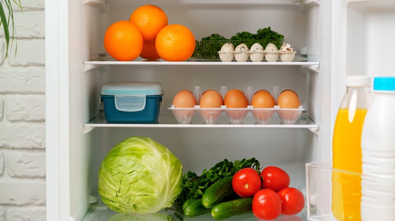 Organized fridge stocked with fresh produce