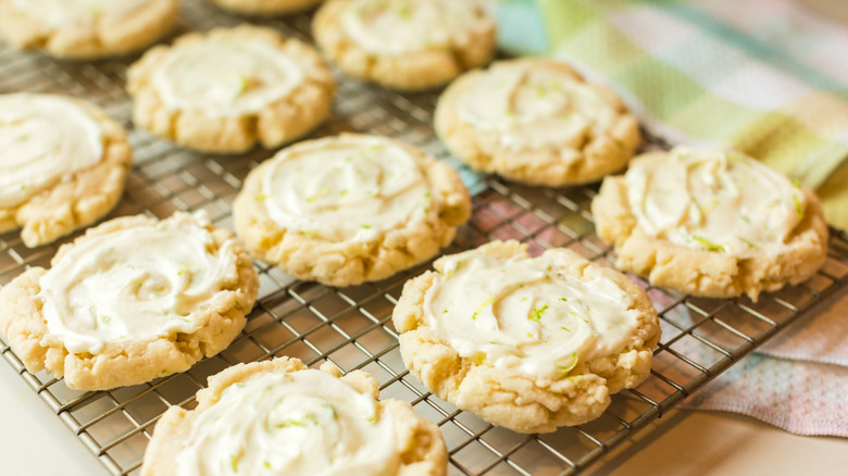 Frosted cookies cooling on a wire rack