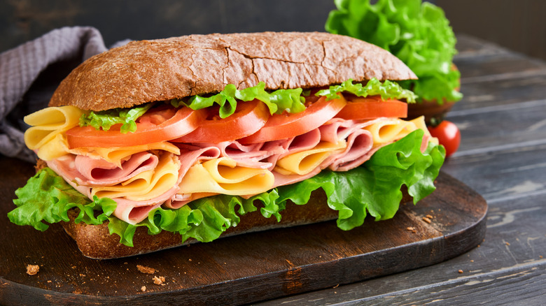 Whole grain hoagie roll packed with meat, cheese, lettuce, and tomatoes