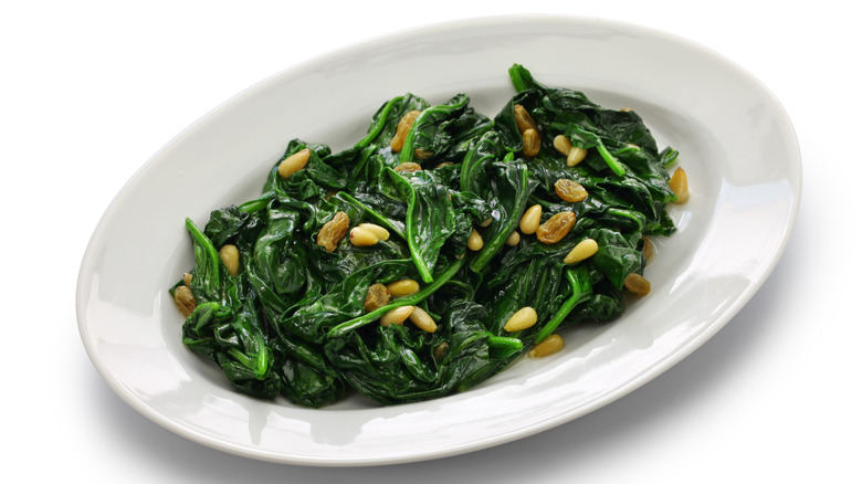 Sautéed spinach in a bowl with pine nuts