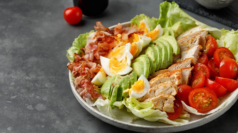 an assembled cobb salad on a gray background