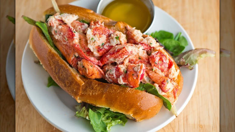 Lobster roll on a toasted New England style hot dog bun, with lettuce and melted butter