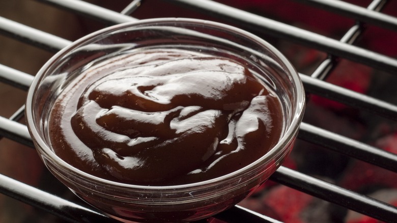 Bowl of barbecue sauce on a grill