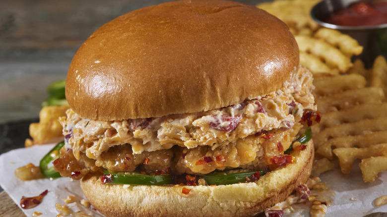 A fried chicken sandwich with pimento cheese