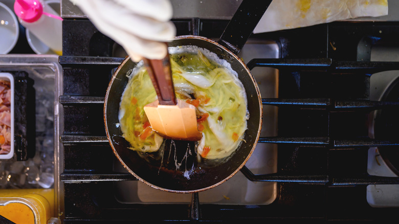 A chef scrambling eggs