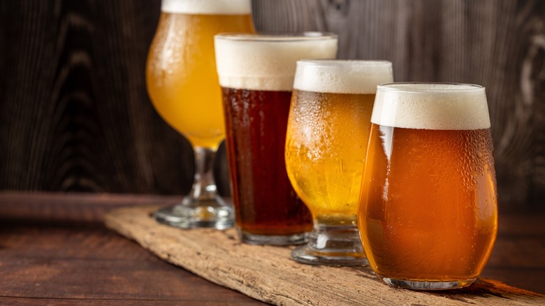 Glasses of beer on a wooden plank