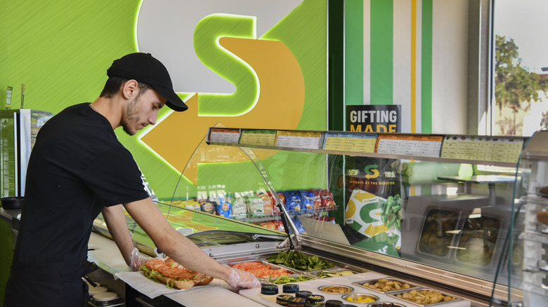 employee making a Subway sandwich